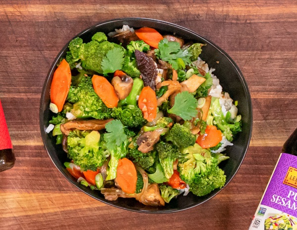 Mixed Vegetable Stir Fry in a black serving bowl on a wooden tabletop